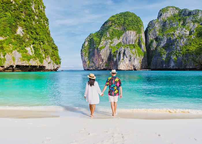 couple-in-front-of-longtail-boat-at-the-lagoon-of-2025-01-08-02-43-56-utc 1